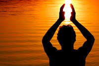 Silhouette of someone holding sun